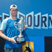 Harry Bourchier hoists the trophy after winning the  2014 18/u Australian Championships title; Elizabeth Xue Bai