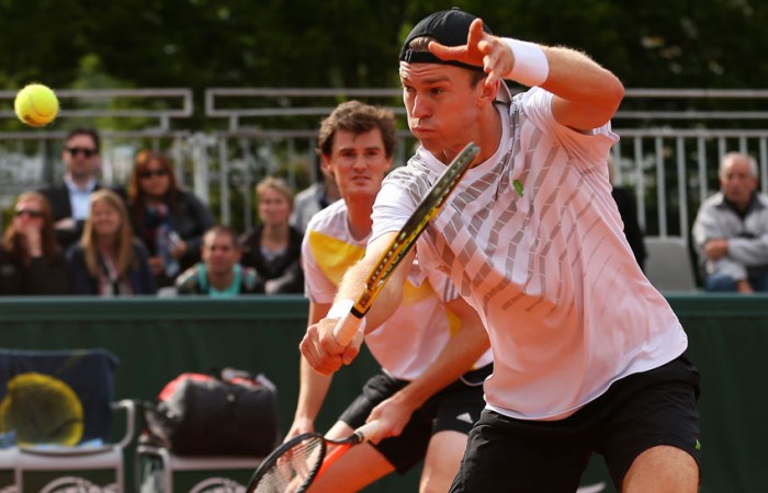 John Peers of Australia plays a backhand volley alongside British partner Jamie Murray in their first round doubles win over Julian Knowle of Austria and Filip Polasek of Slovakia on Day 4 of the French Open; Getty Images
