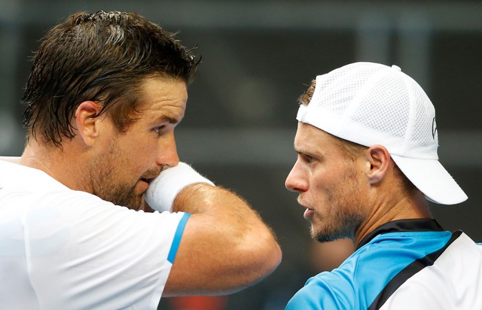 2014 Australian Open, Melbourne, Pat Rafter and Lleyton Hewitt MELBOURNE, AUSTRALIA - JANUARY 15: Pat Rafter of Australia and Lleyton Hewitt of Australia talk between points in their first round men's doubles match against Eric Butorac of the United States and Raven Klassen of South Africa during day three of the 2014 Australian Open at Melbourne Park on January 15, 2014 in Melbourne, Australia. (Photo by Scott Barbour/Getty Images)