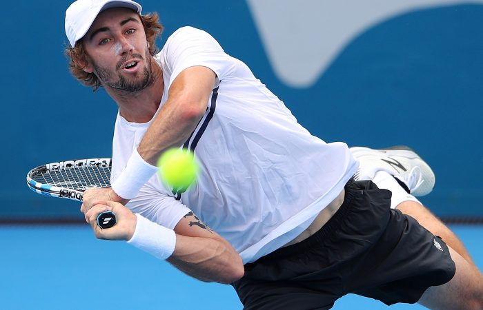 Jordan Thompson plays a backhand in the searing Sydney heat. Jordan Thompson plays a backhand in the searing Sydney heat.